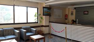 a waiting room with two chairs and a counter at Saala Hotel Limited in Gatunga