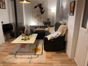 ein Wohnzimmer mit Sofa und Tisch in der Unterkunft La Villa in Viviers-du-Lac