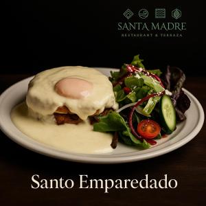 a plate of food with an egg and a salad at Santa Madre B&B in San Luis Potosí