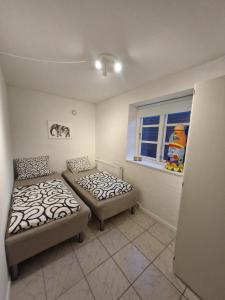 a bedroom with two beds and a window at Cozy Airport stay in Copenhagen
