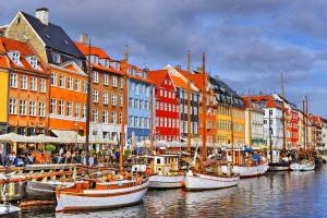 a group of boats docked in a harbor with buildings at Cozy Airport stay in Copenhagen