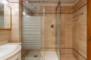a bathroom with a shower with a toilet and a sink at Valencia Beach Vibe by Vireta Suites in Valencia