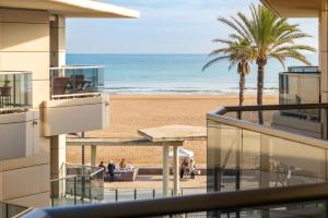 a view of the beach from the balcony of a building at Valencia Beach Vibe by Vireta Suites in Valencia