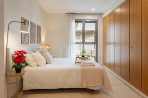 a bedroom with a large bed and a window at Valencia Beach Vibe by Vireta Suites in Valencia