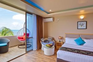 a hotel room with a bed and a balcony at Season Paradise in Thulusdhoo