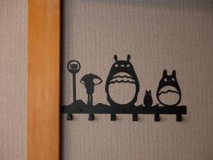 a sign with three cats sitting on a shelf at 貸切宿ひととき in Numazu +151 photos