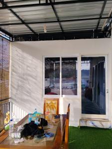 a room with a table and a window at Komodo Village Tour & Homestay in Komodo