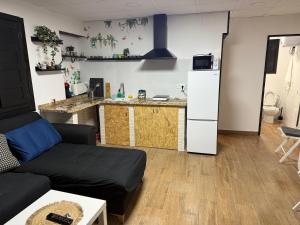 a living room with a couch and a kitchen at Loft Ohanes in Ohanes +4 photos