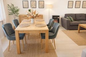 a dining room table and chairs in a living room at Ferienhaus Seeblick Westerwald in Mengerskirchen