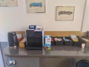 a counter top with a coffee maker and a microwave at B&B La meridiana in Porte di Rendena