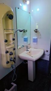 a bathroom with a sink and a mirror at Sai Dwarka Alibag Hotel in Alibaug +27 photos