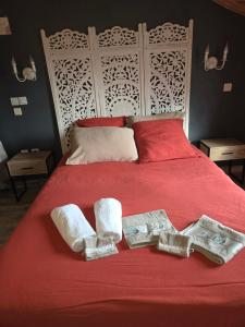 a bed with two towels and two crosses on it at La mare aux canards in Châteauvieux