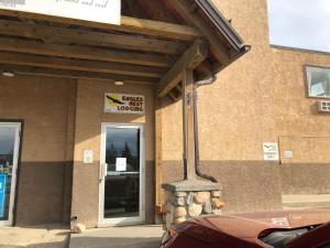 a building with a sign on the side of it at Eagles Nest Lodging in Hinton +2 photos