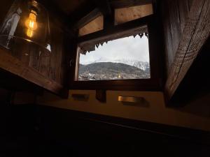 a window in a room with a view of a mountain at We Are 4810 LA CORDE D'ESCALADE in Courmayeur