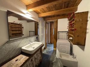 a bathroom with a sink and a toilet at We Are 4810 LA CORDE D'ESCALADE in Courmayeur +1 photo