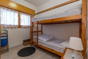 Giường trong phòng chung tại Appartamento Cordevole PT