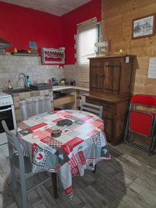 a kitchen with a table with a blanket on it at La mare aux canards in Châteauvieux