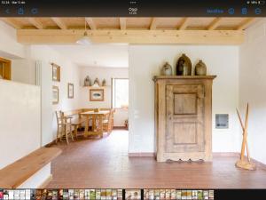 a room with a wooden door and a dining room at Alla Casetta B&B in Cesiomaggiore