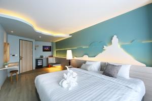 Postel nebo postele na pokoji v ubytování Hatyai Signature Hotel