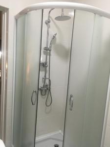 a shower with a glass door in a bathroom at Studio Cosy MM in Tbilisi City