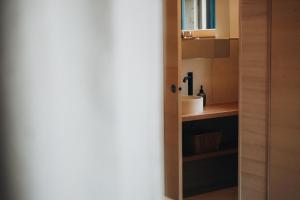 a bathroom with a sink and a mirror at Zalbander Chalets in Silbertal +30 photos