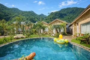 an image of a swimming pool with a house at Mộc Sơn Homestay in Mộc Châu