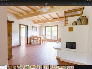 a living room with a fireplace and a dining room at Alla Casetta B&B in Cesiomaggiore