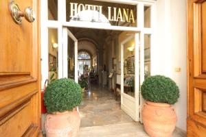 a entrance to a store with two large vases at Hotel Villa Liana in Florence