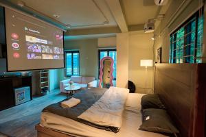 a room with a large bed and a projection screen at Trên Mây HST - 91 Cầu Diễn in Văn Trì