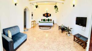 a living room with a couch and a tv at Kandy Villa 119 in Kandy