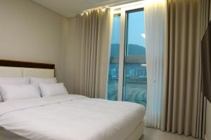 a bedroom with a bed and a large window at Two Rest Pension in Damyang