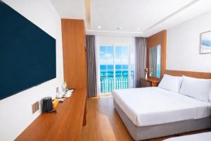 En eller flere senge i et værelse på Great Hotel Phú Quốc