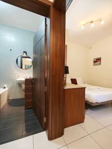 a bathroom with a door leading to a bedroom at Speranza in Il-Gżira +22 photos