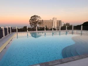 a large swimming pool on top of a building at Aston Hotel Pattaya in Pattaya