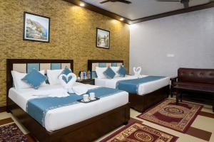 a hotel room with two beds and a piano at Hotel The Ayodhya Ji Palace-Walking Distance From Ram Mandir in Ayodhya