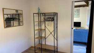 een kamer met een kast met planken en een spiegel bij Maison calme in Pleumeleuc