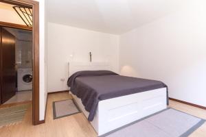 a bedroom with a bed in a white room at Venice Biennale Garibaldi in Venice +7 photos