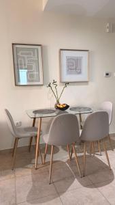 a dining room with a table and chairs at Dar Al Noor Apartment in Dubai +18 photos