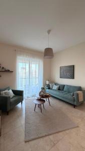 a living room with a green couch and a table at Dar Al Noor Apartment in Dubai