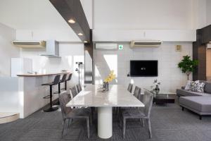 a living room with a table and chairs and a couch at Bijou Suites AI PREMIUM in Osaka