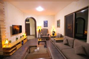 a living room with a couch and a tv at Sardar Villa NathiGalli in Bāzār +27 photos