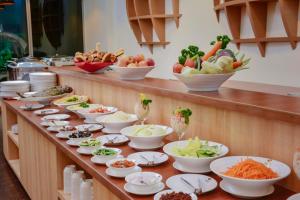 a buffet line with bowls and plates of food at Season Paradise in Thulusdhoo