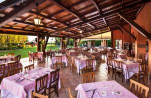 a restaurant with tables and chairs with purple tablecloths at Podere Del Gesso in Tarquinia