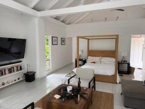 a living room with a large bed and a table at Tabu in La Digue +18 photos