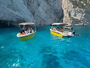 two boats with people on them in the water at Tsilivi Yellow Boats in Zakynthos