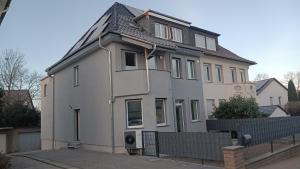 a large white house with a roof at Apartment -Wohnung Herford in Herford