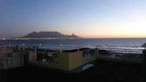 a view of the ocean from the balcony of a building at 210 Atlantic Sun in Bloubergstrand