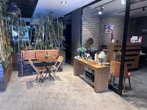 a dining room with a table and chairs and plants at Meydan Besiktas Hotel in Istanbul