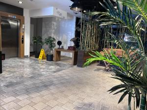a lobby with potted plants in a building at Meydan Besiktas Hotel in Istanbul