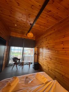 a bedroom with a bed and a wooden wall at Palmera suit in Sapanca